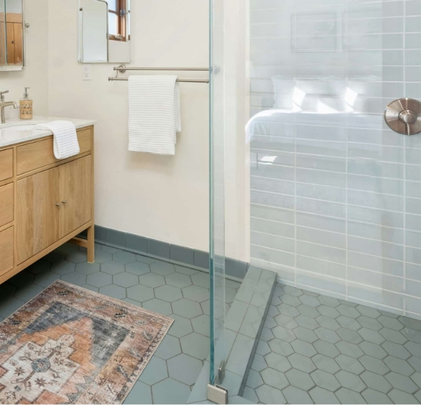 A bathroom featuring a shower and sink, showcasing flooring services available in Destin.
